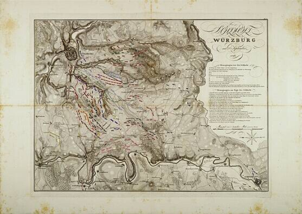 Ein detaillierter alter Stadtplan von Würzburg, Deutschland, der Straßen, Gebäude und Sehenswürdigkeiten zeigt, mit Text, der zusätzliche Stadtinformationen bereitstellt.